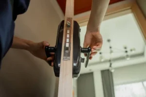 A person performs a lock replacement in Toronto, carefully installing a lock mechanism into a wooden door and holding the hardware steady while aligning it with the door's edge. Locksmith in Heart Lake Can a Locksmith in Toronto Install a Smart Lock? Residential Locksmith Cliffside