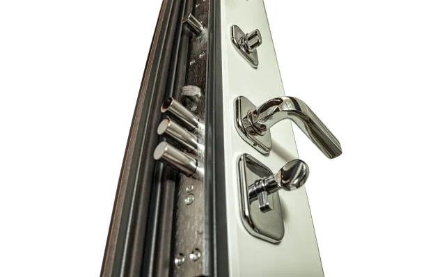Close-up of a secure metal door with a locking handle, multiple deadbolt locks, and a reinforced frame on a white background.
